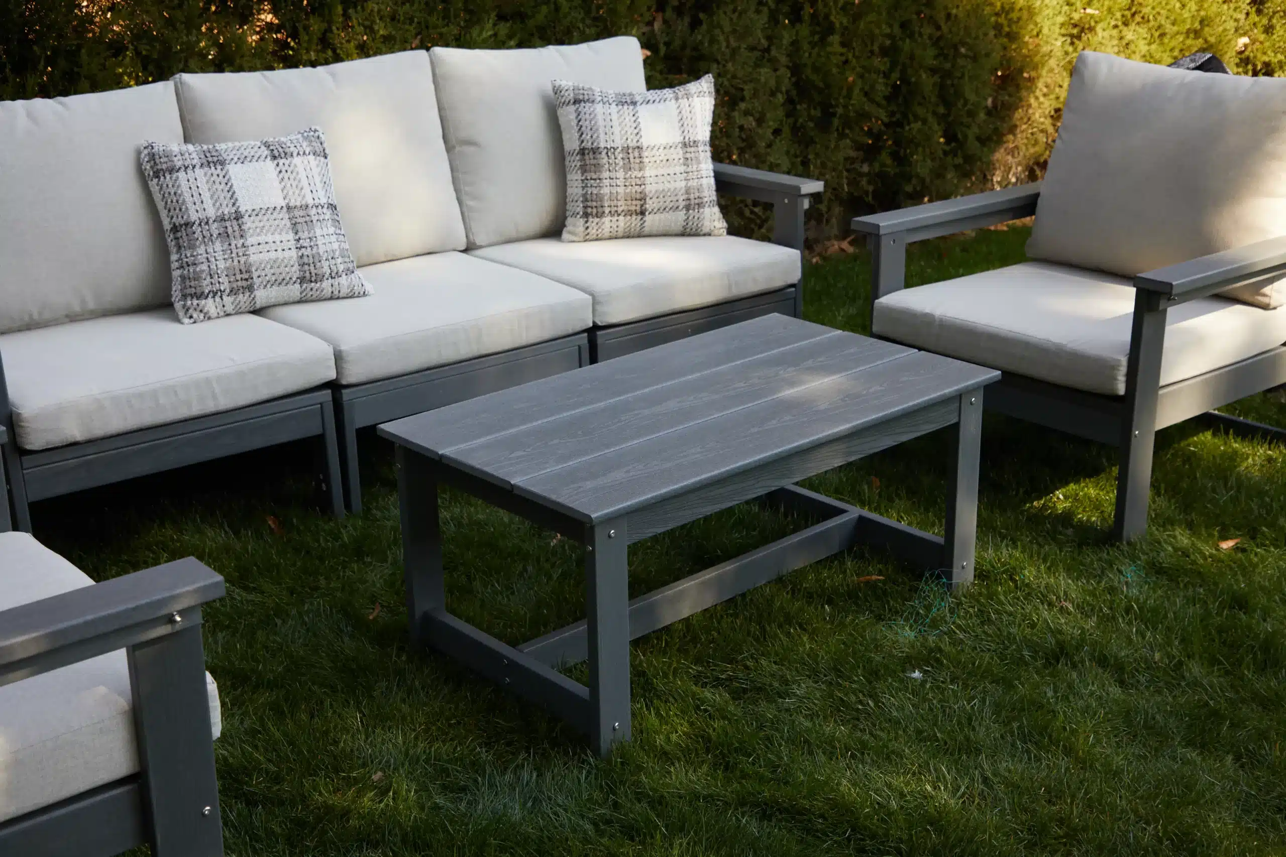 The dark gray adirondack coffee table with sofa on the glass