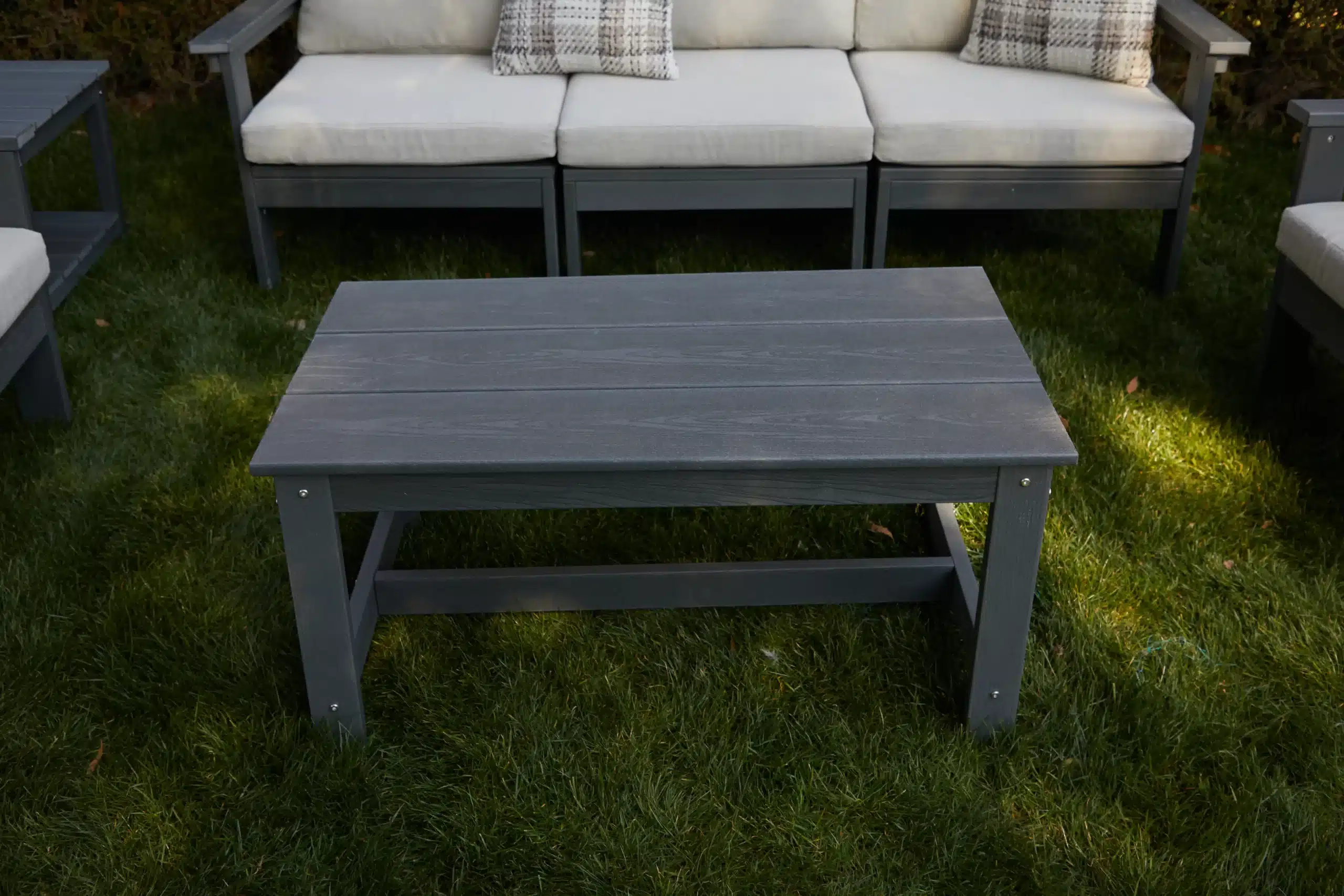 The gray adirondack coffee table in the outdoor sectional sofa set