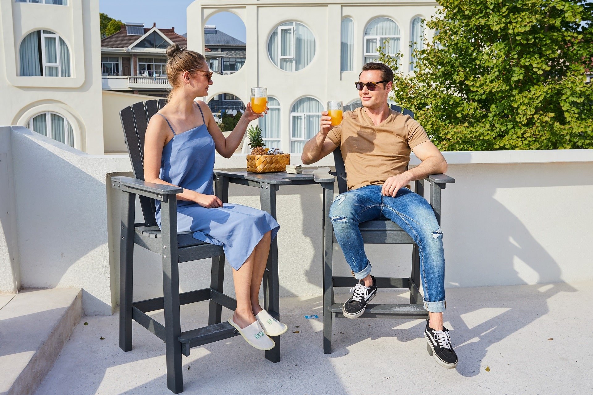 Couple sitting on the bar height Adirondack chair chatting