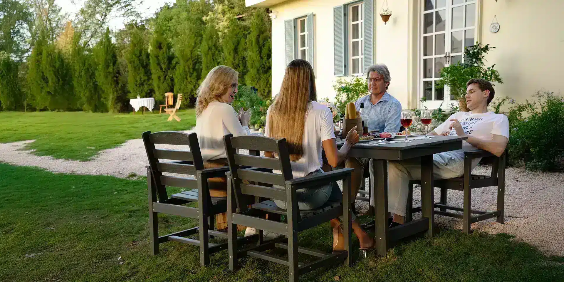 Family having dinner at the gray outdoor poly dining table