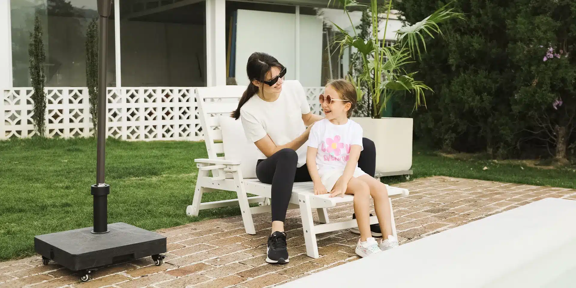 Mother and daughter playing on a lounge chair