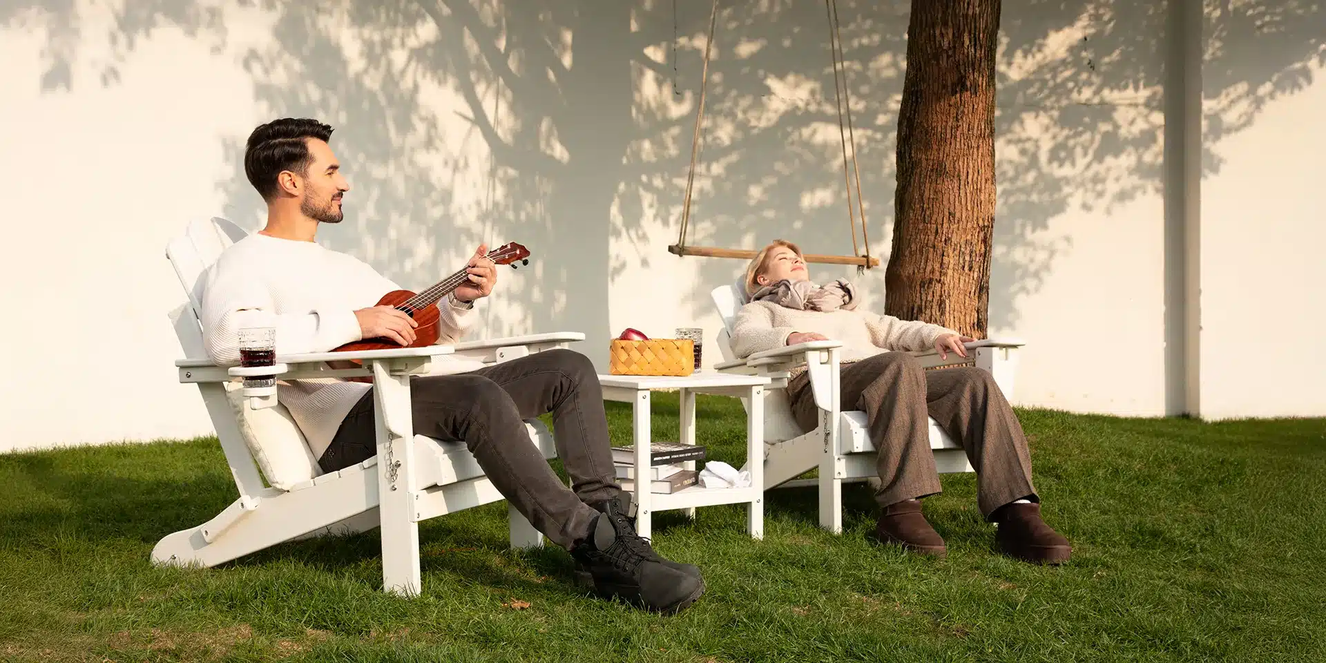A Couple Enjoy outdoor time on the white classic Adirondack Chairs