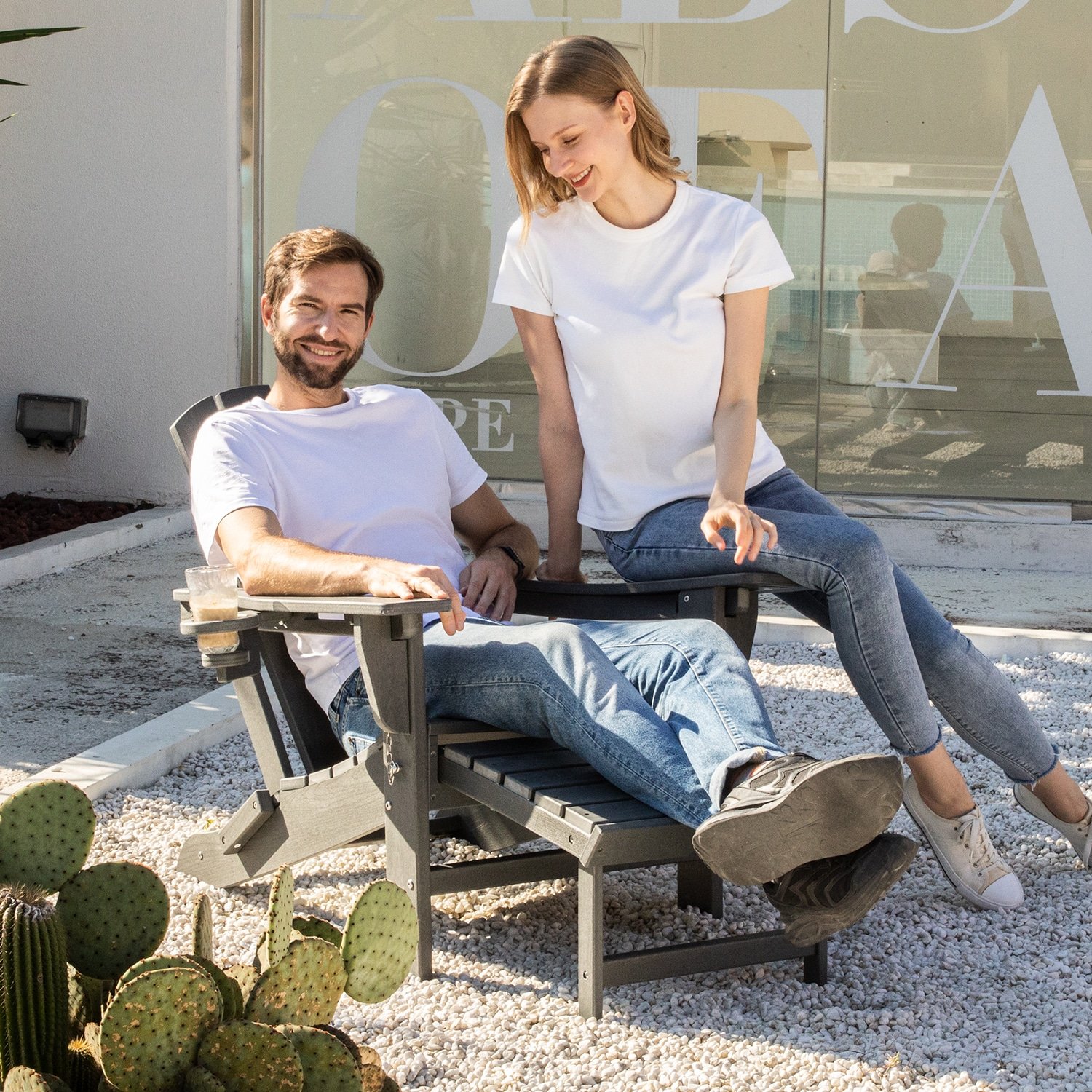 A Couple sitting on the Adirondack Chair with Pull-out Ottoman