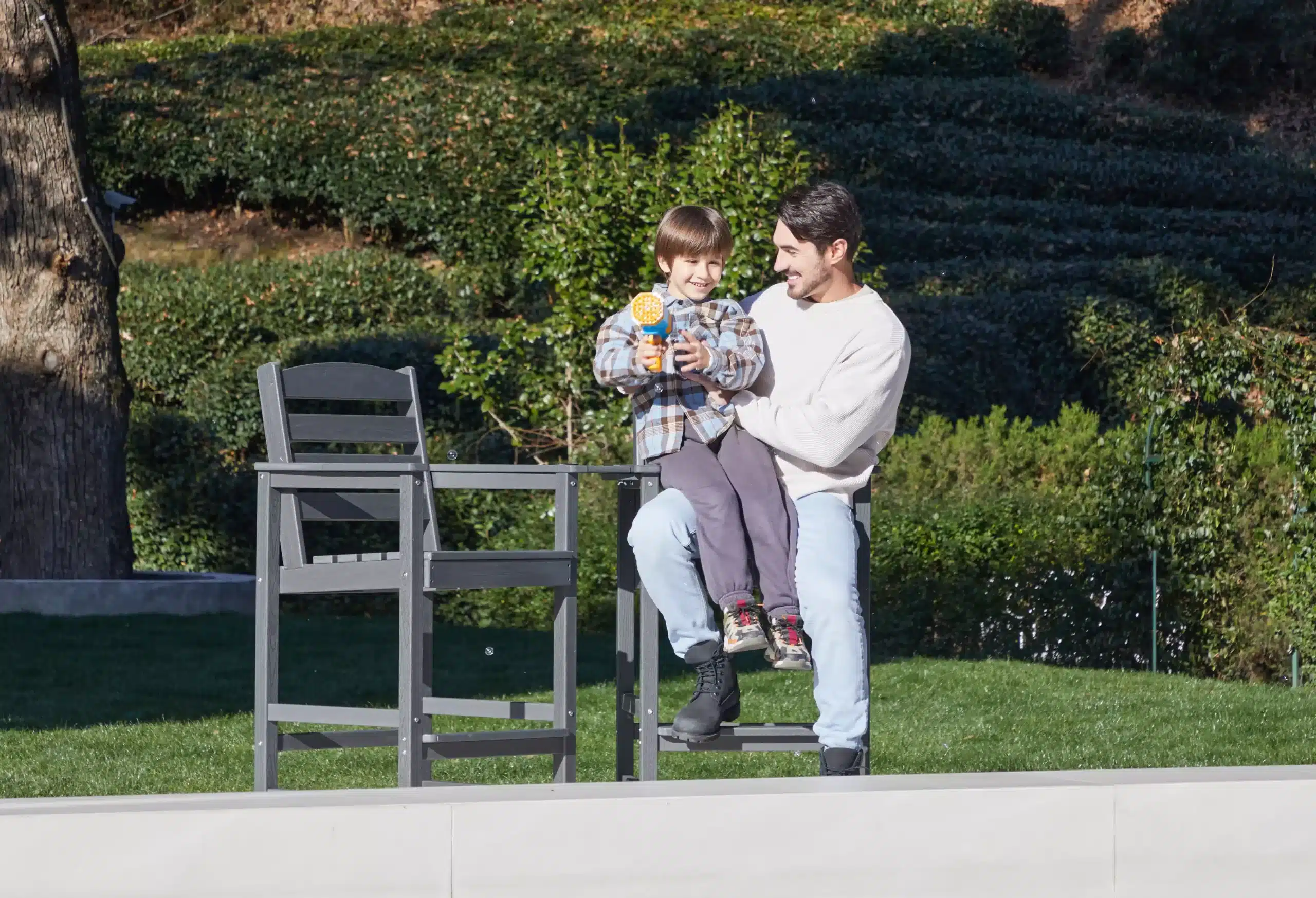 Dad and Son Sitting on Counter Height Stool with Arms