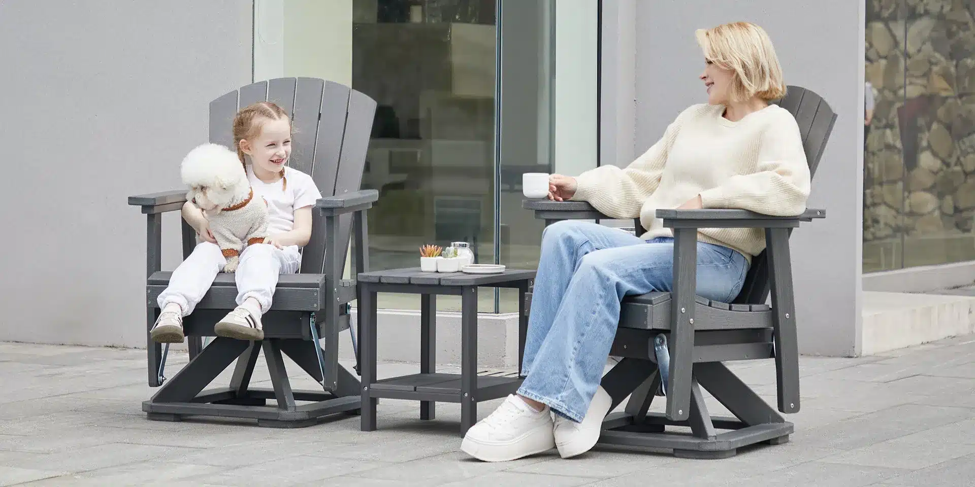 A mon and her daughter relaxing on the Swivel Adirondack Chair