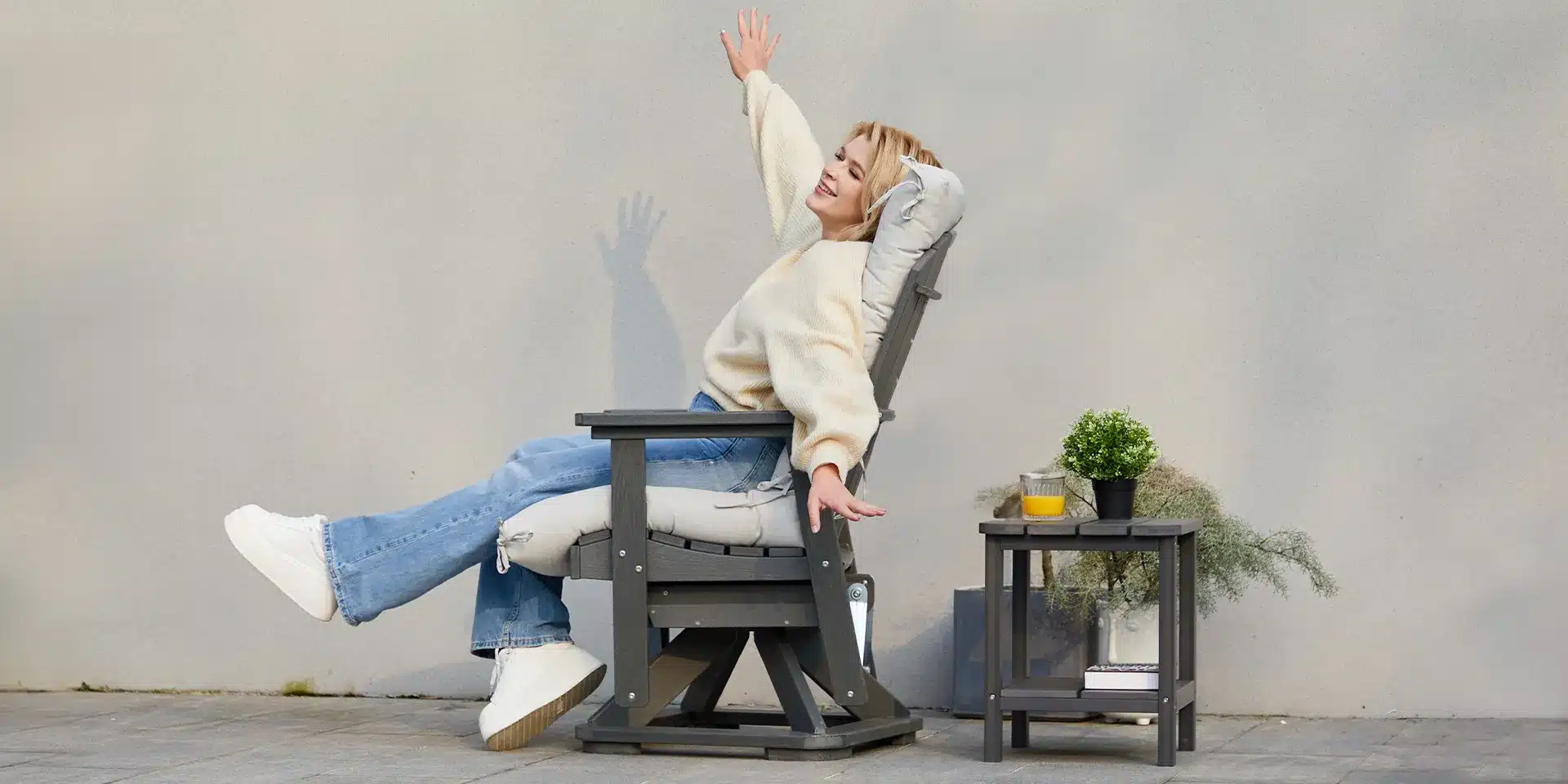 A woman relaxing on the outdoor swivel glider chair​
