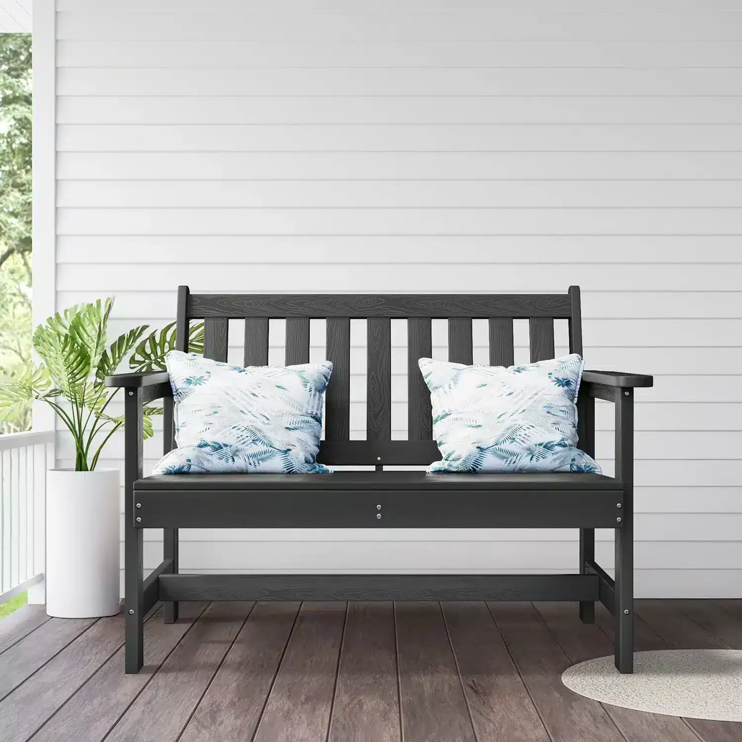 Outdoor garden bench with floral cushions on porch