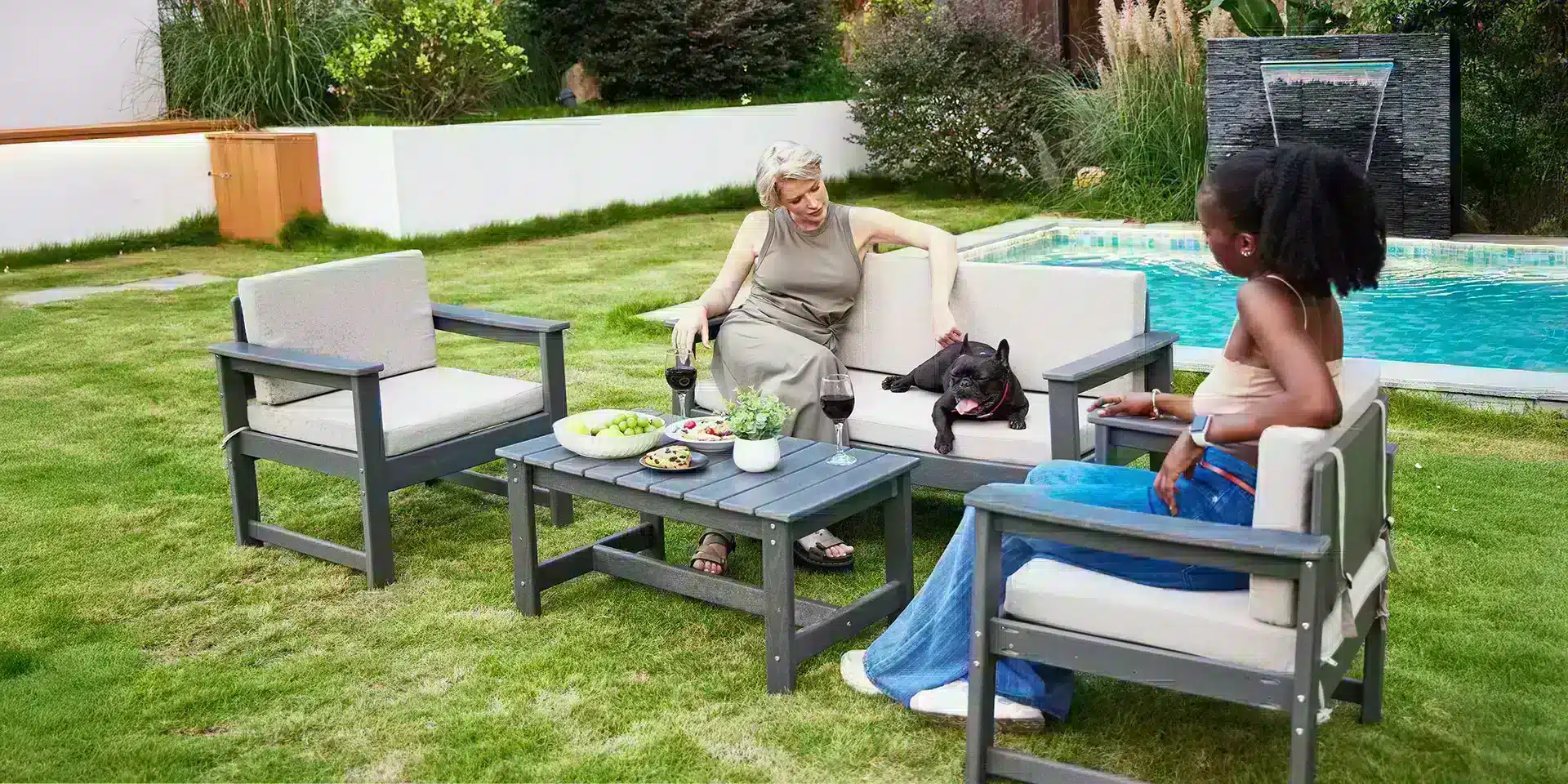 Elegant ladies sitting on the deep seating sofa chat