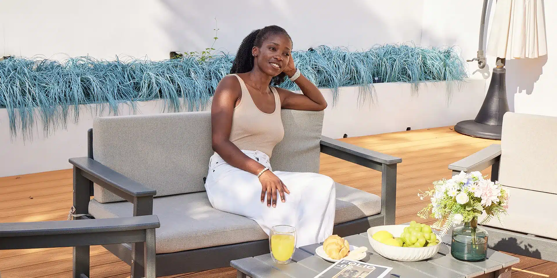 A woman sit on the deep seating patio sofa
