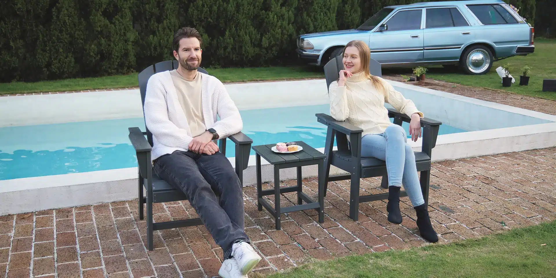 A couple chatting on the 2-piece Adirondack Dining Chair