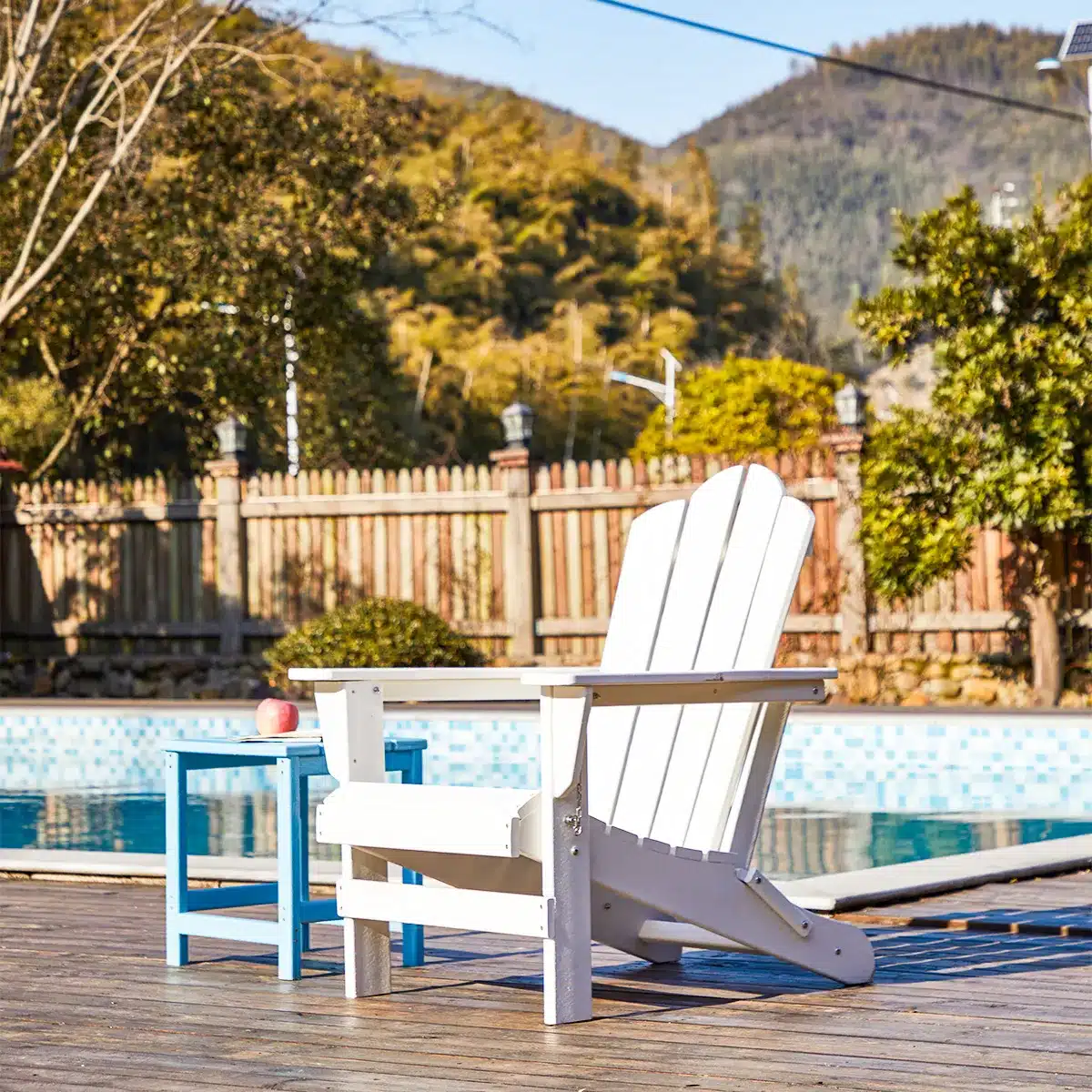 a adirondack chair by the pool