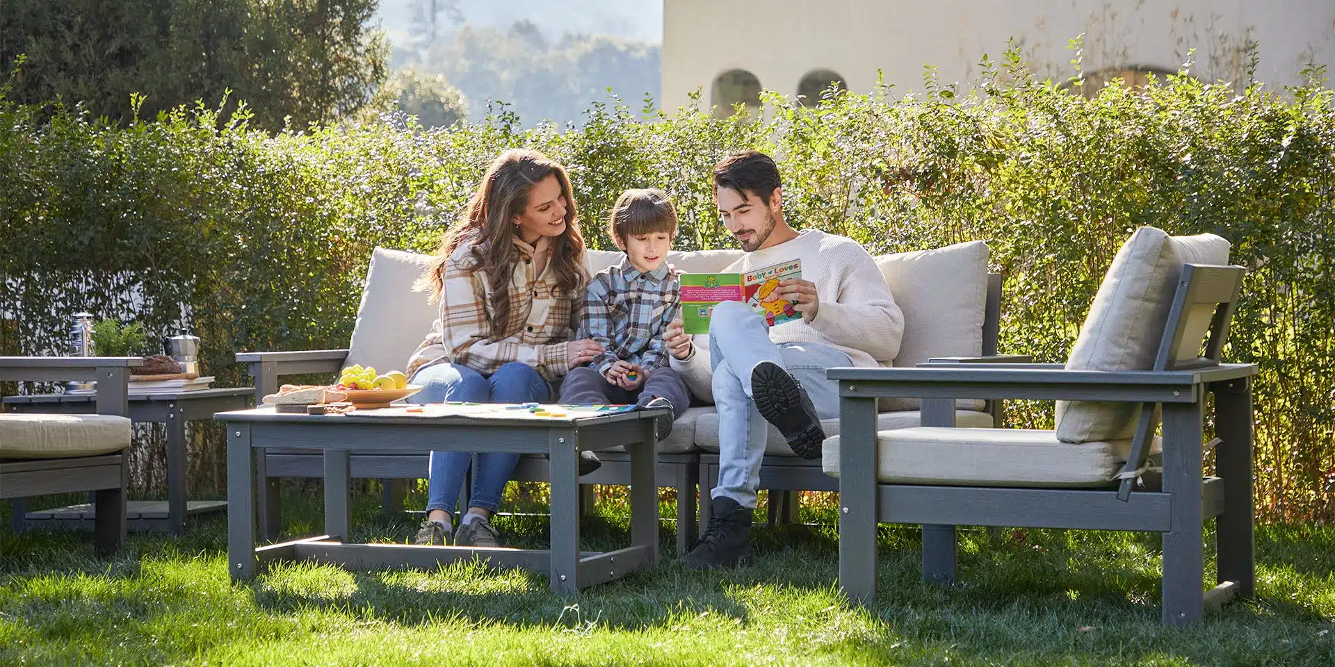 a family play on the outdoor sofa